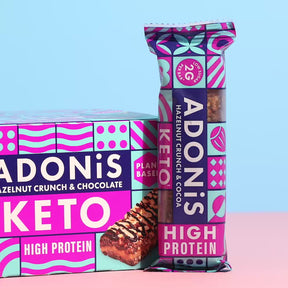 Hazelnut Crunch keto bar being broken apart and eaten